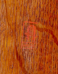 Early Gustav Stickley red decal signature, "Stickley" in a box below a joiners compass surrounding the words "Als Ik Khan".  1902-1904.